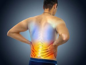 Lower back pain. Man holding his back in pain. Medical concept.